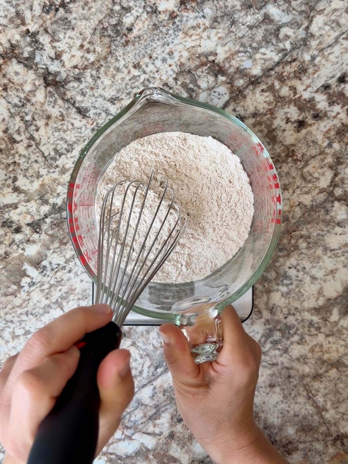 The dry ingredients whisked together in a large glass measuring cup.