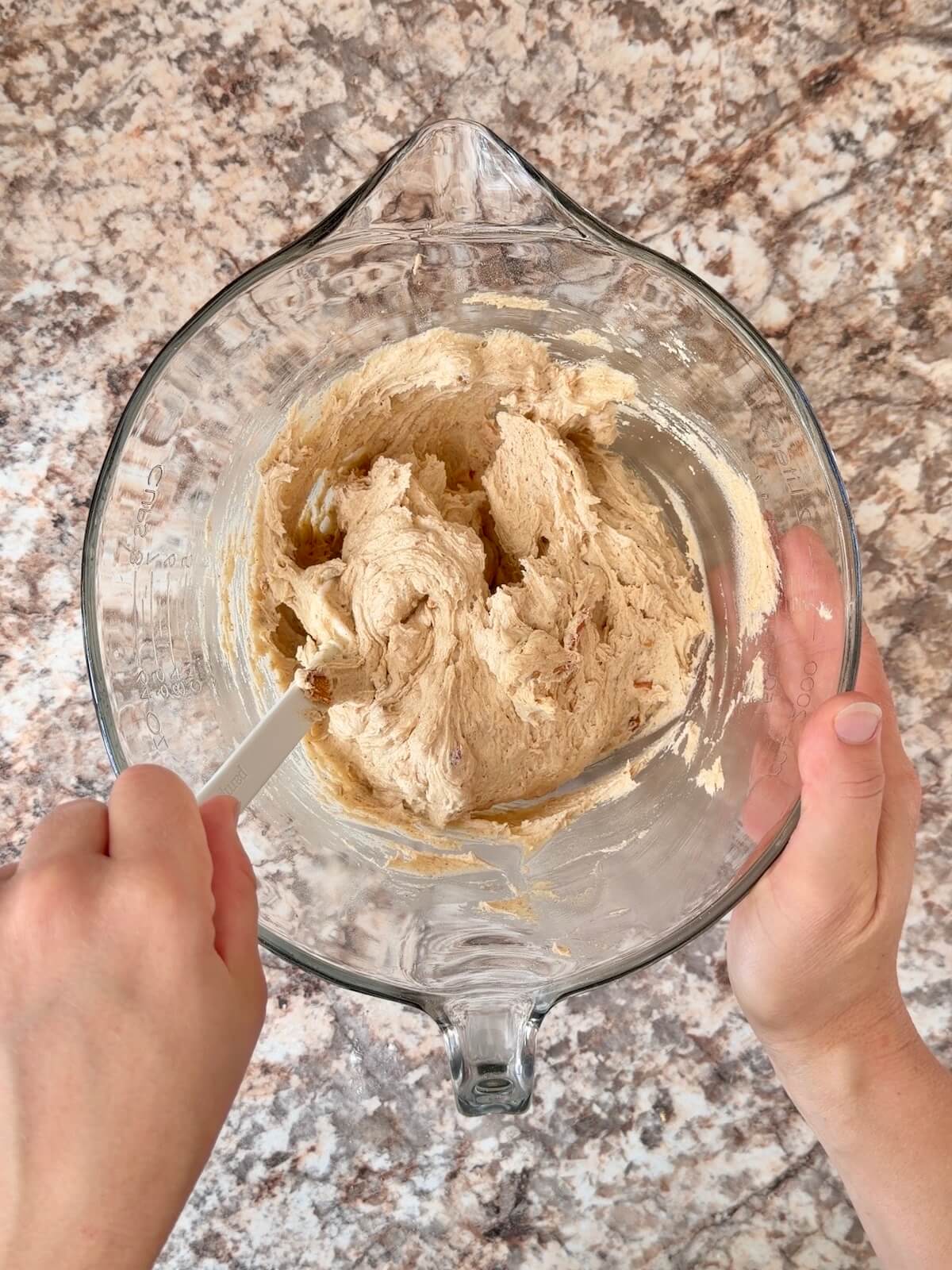 Caramel apple sourdough cookie dough in a glass bowl.