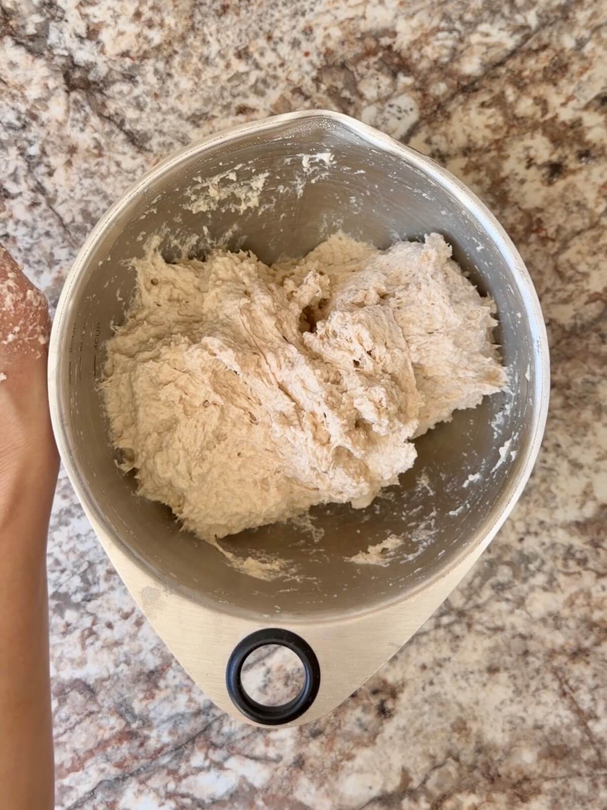 Sourdough bread dough mixed together in a bowl.