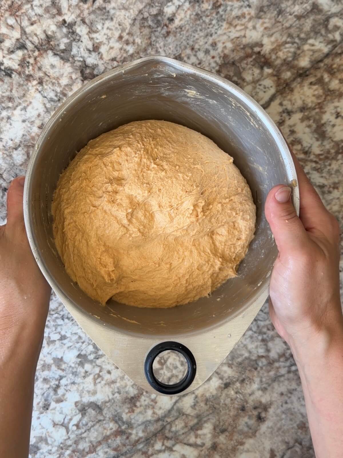 Sourdough pumpkin focaccia dough in a bowl after the first round of stretch and folds.