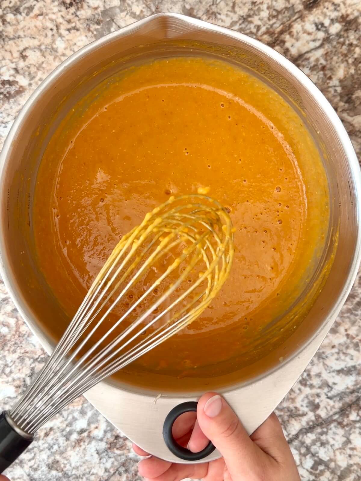 Pumpkin puree, active sourdough starter, and water whisked together in a large mixing bowl.
