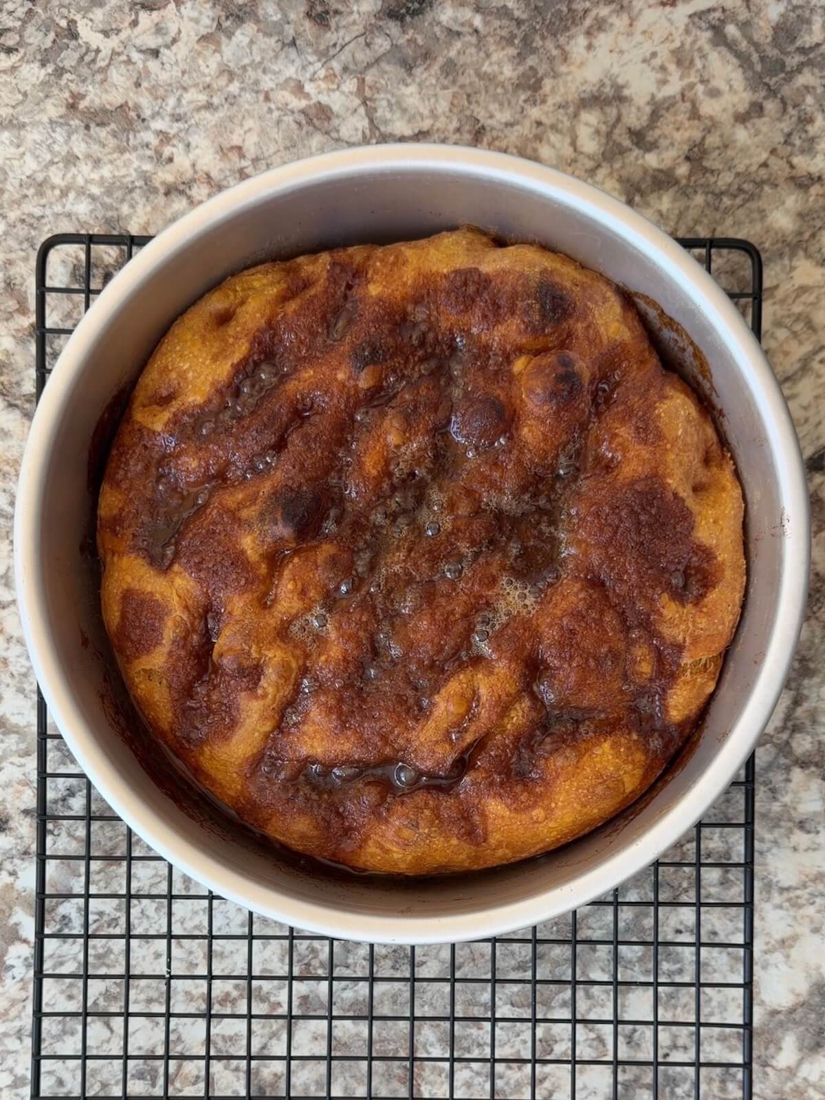 Pumpkin spice sourdough focaccia baked in a round pan.