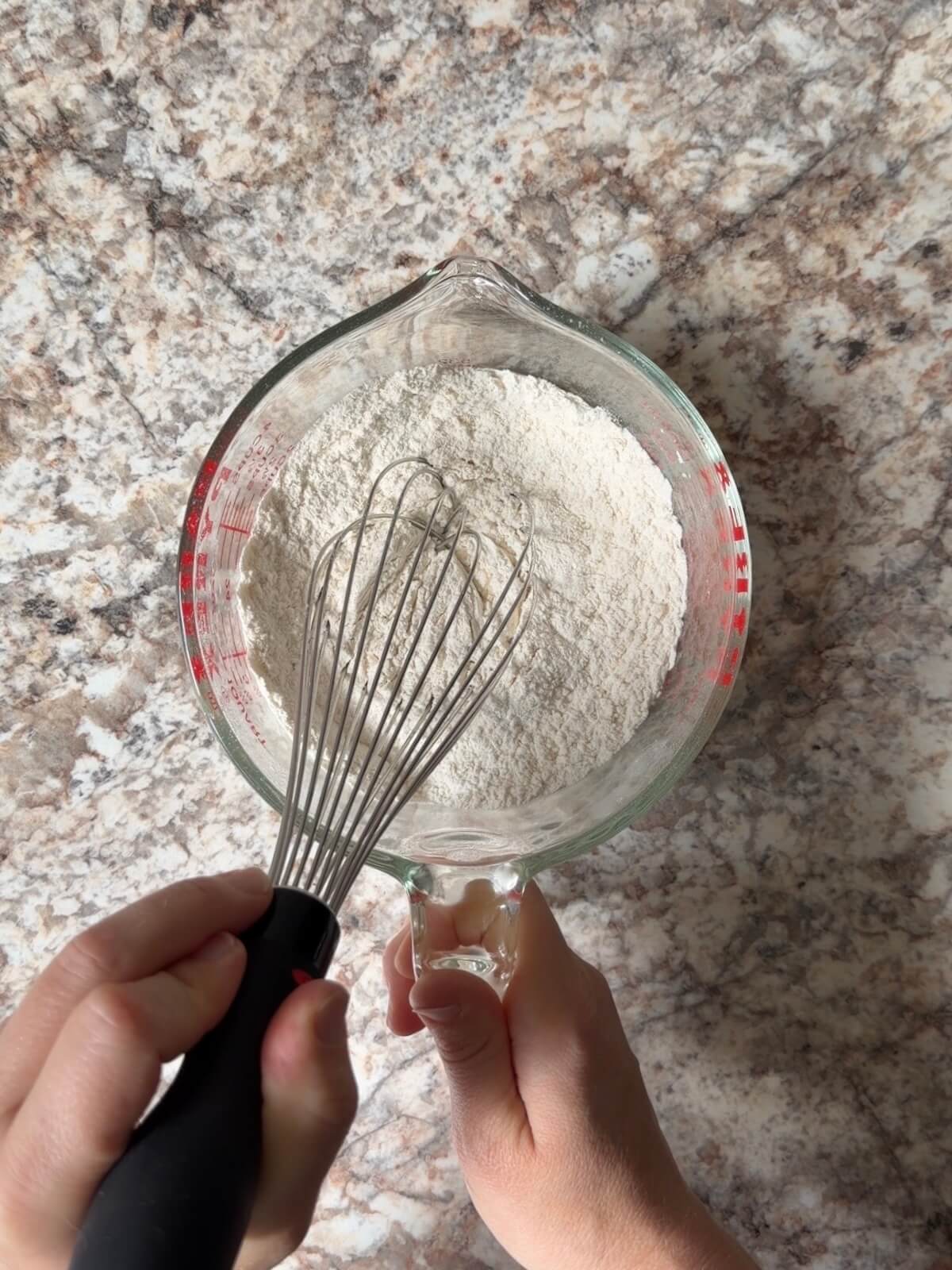 The dry ingredients whisked together in a large glass measuring cup.