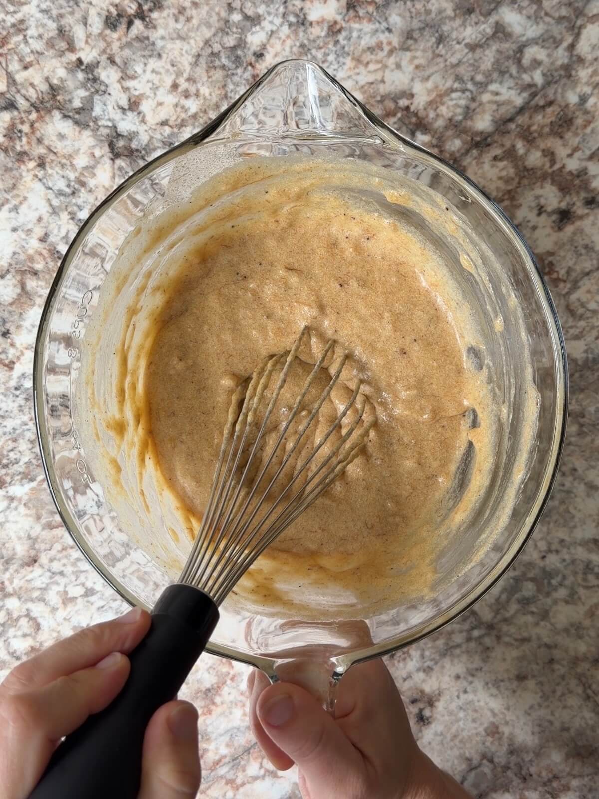 The wet ingredients whisked together in a large glass bowl.