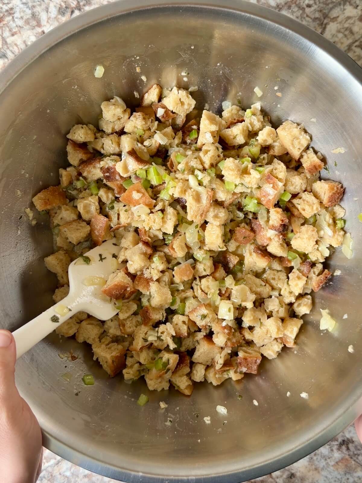 Sourdough bread stuffing mixed together in a large bowl.