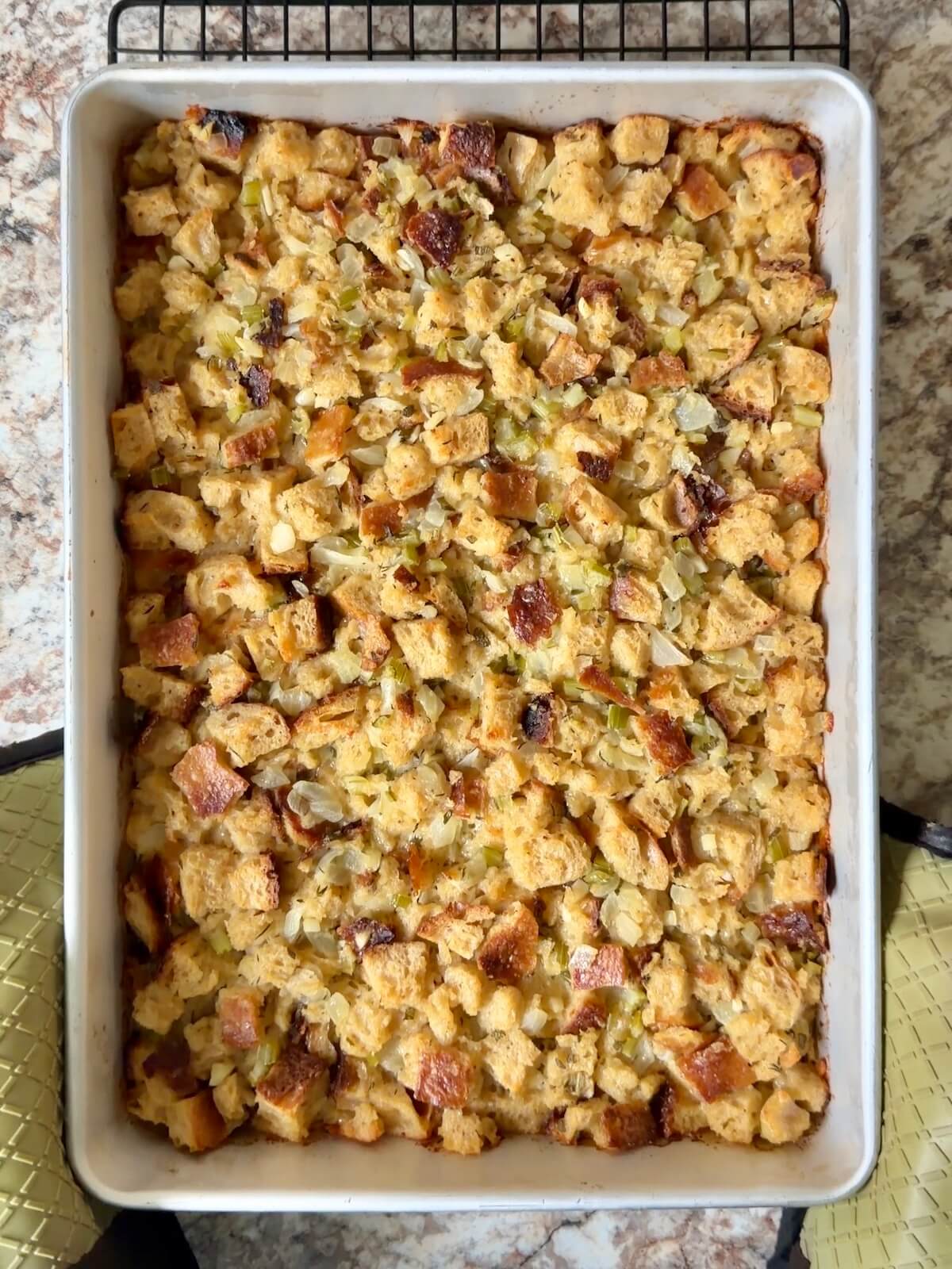 Baked sourdough bread stuffing in a 9x13" pan.