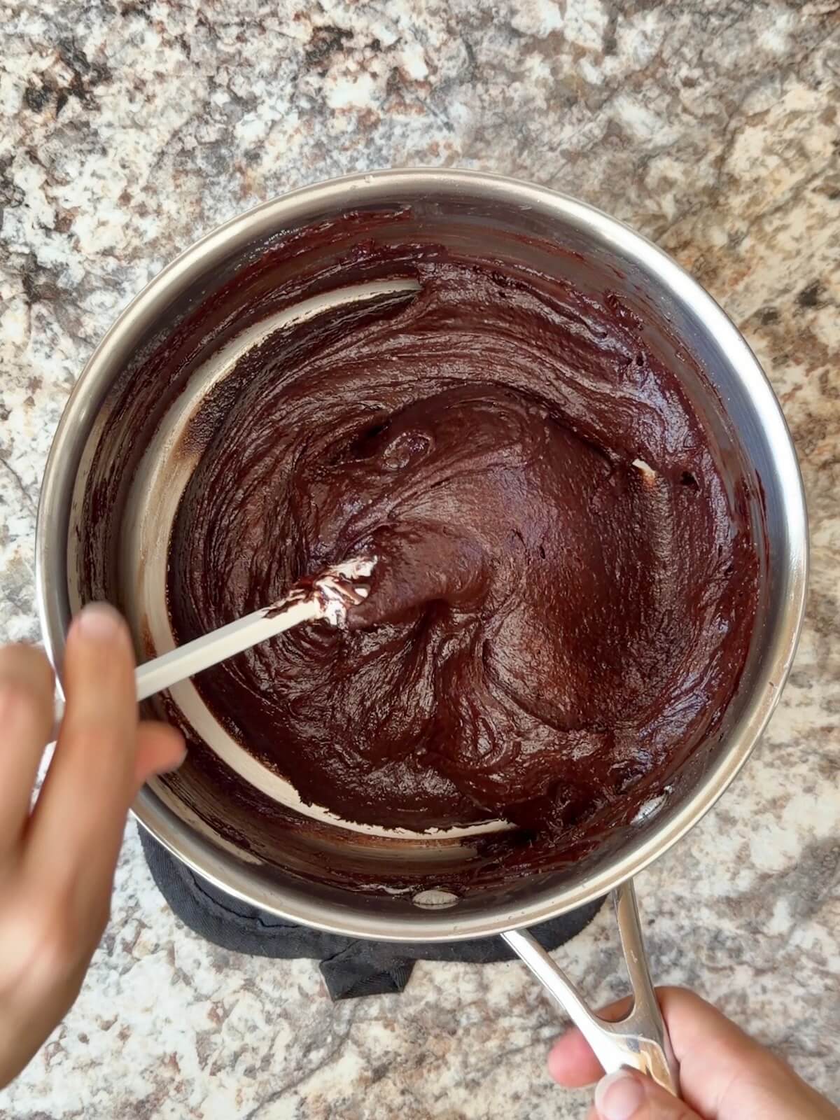Sourdough brownie batter in a stainless steel pot.