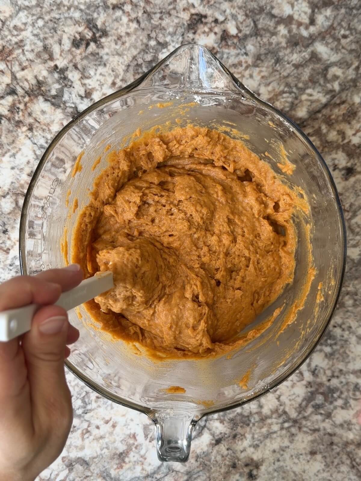 Sourdough pumpkin muffin batter folded together in a large bowl.