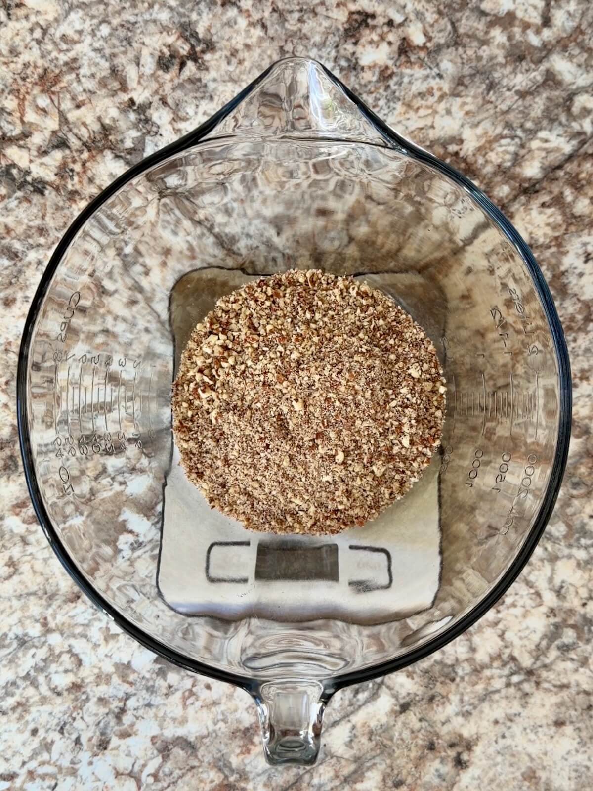 Ground pecans in a mixing bowl.