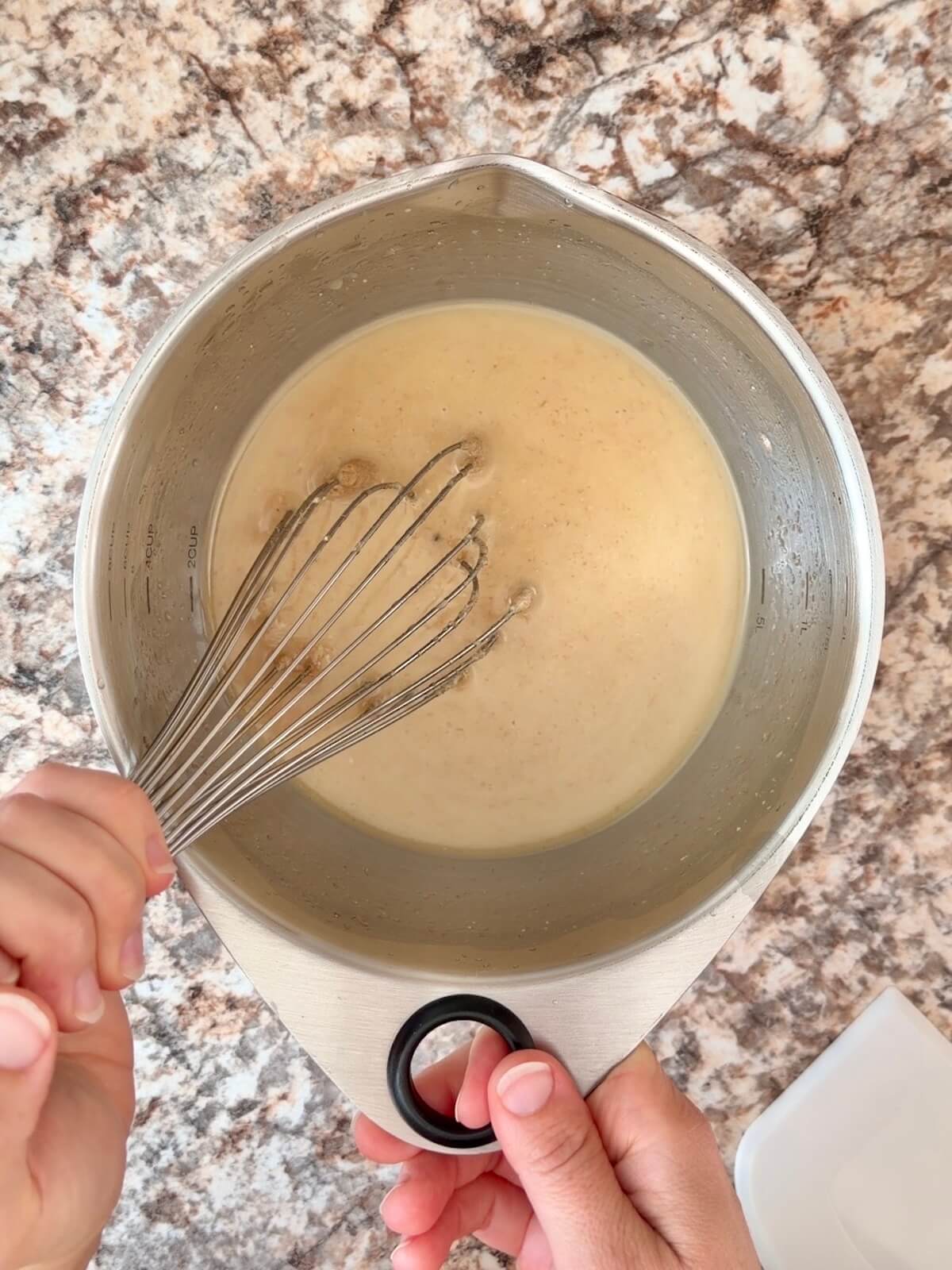 Turkey stock and active sourdough starter whisked together in a bowl.